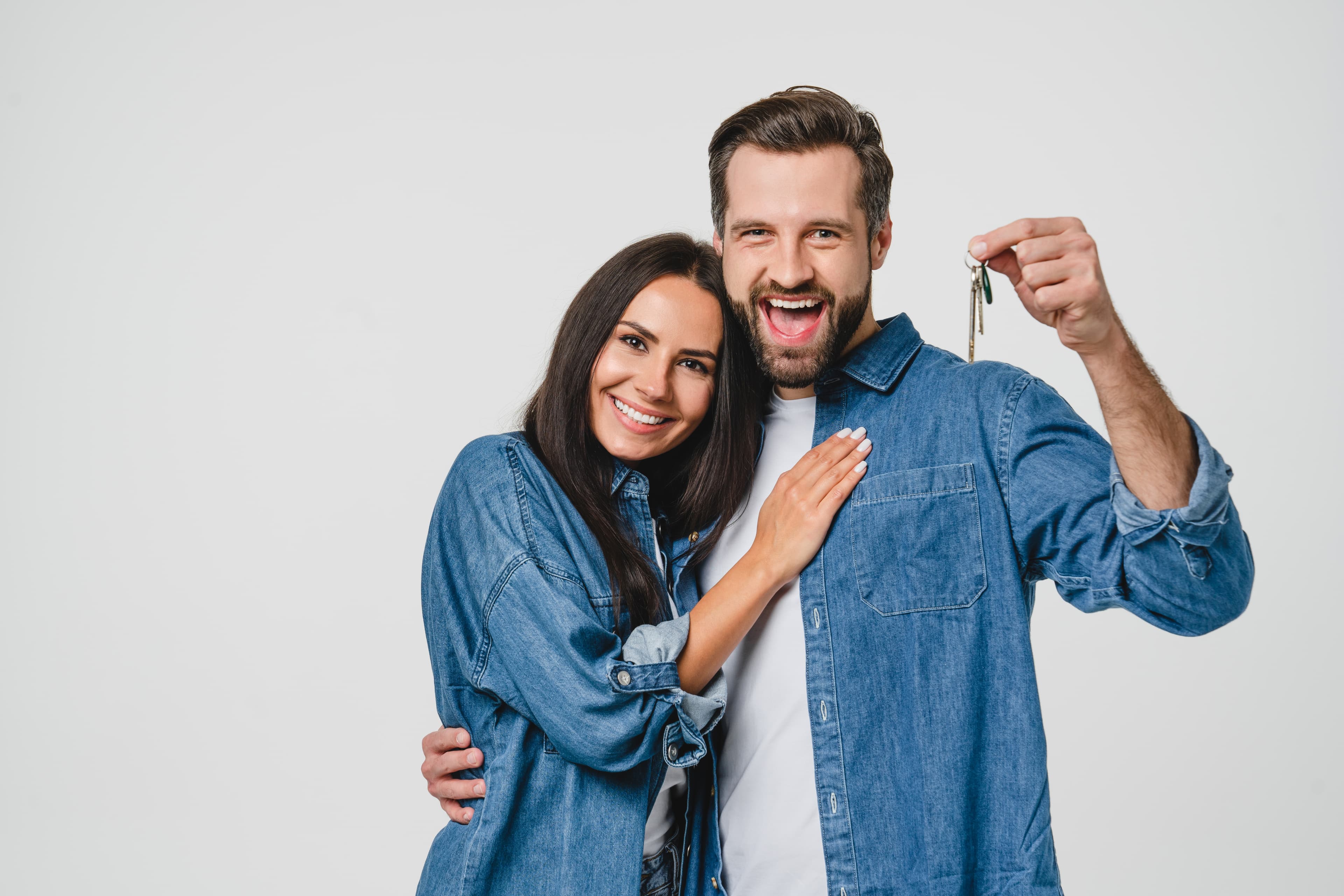 Happy couple smiling together dressed in matching denim outfits